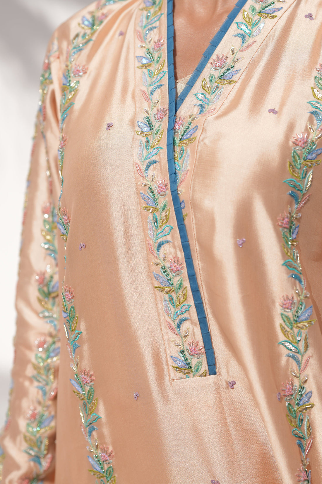 Close-up of hand embroidery detail on Coral Drizzle kaftan in sheesha silk by La Soie