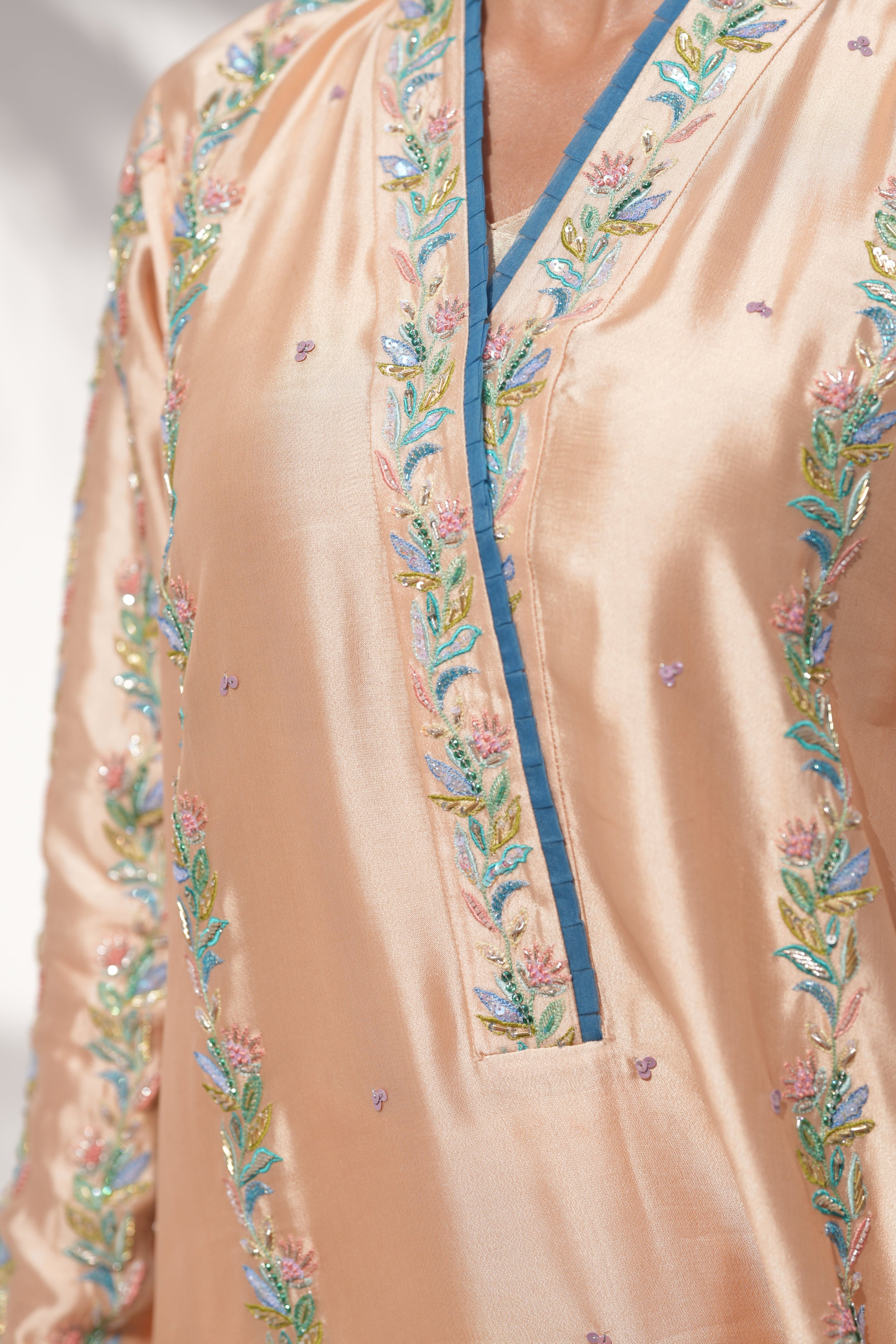 Close-up of hand embroidery detail on Coral Drizzle kaftan in sheesha silk by La Soie