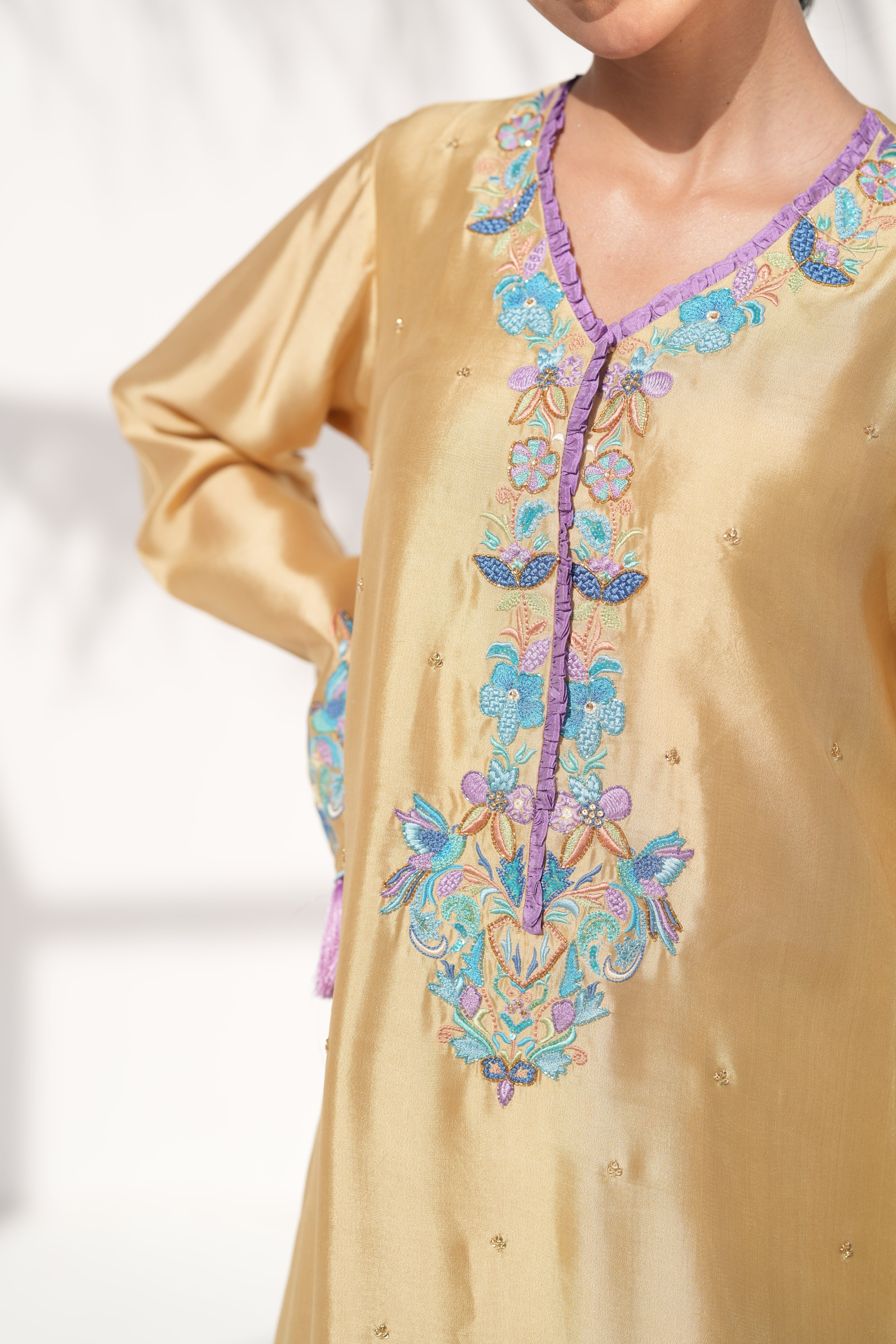Beige kurta with colorful floral embroidery on a white background